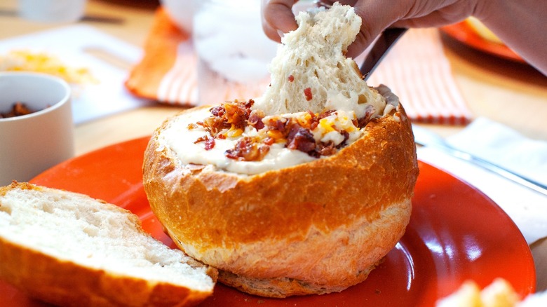 Clam chowder in bread bowl with bacon pieces