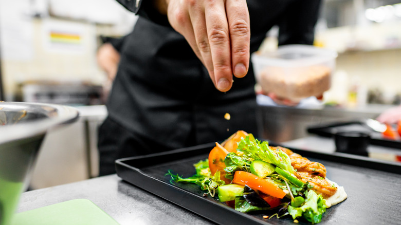Chef garnishing plate