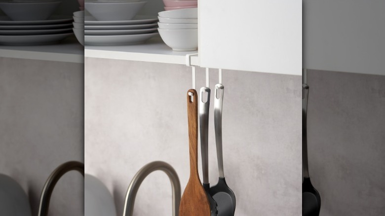 white Pålycke clip-on hook rack holding kitchen utensils