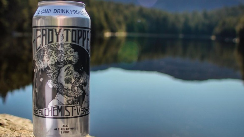 Heady Topper beer can in front of lake