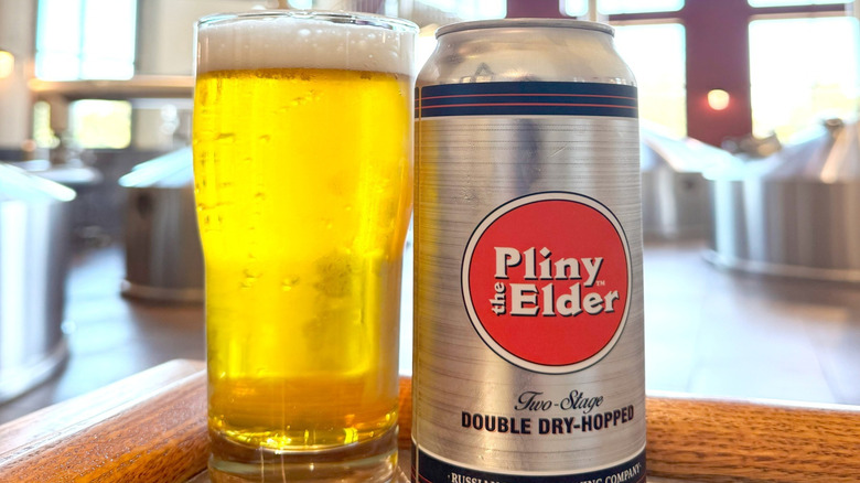 Pliny the Elder beer can next to filled beer glass