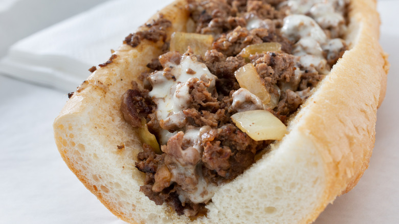 Close-up of a cheesesteak with onions
