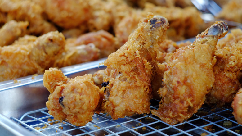 Pieces of fried chicken on cooling rack