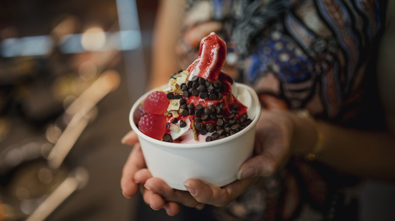 Holding a cup of frozen yogurt