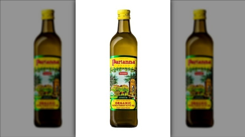 A bottle of Partanna Organic Extra Virgin Olive Oil on a white background.