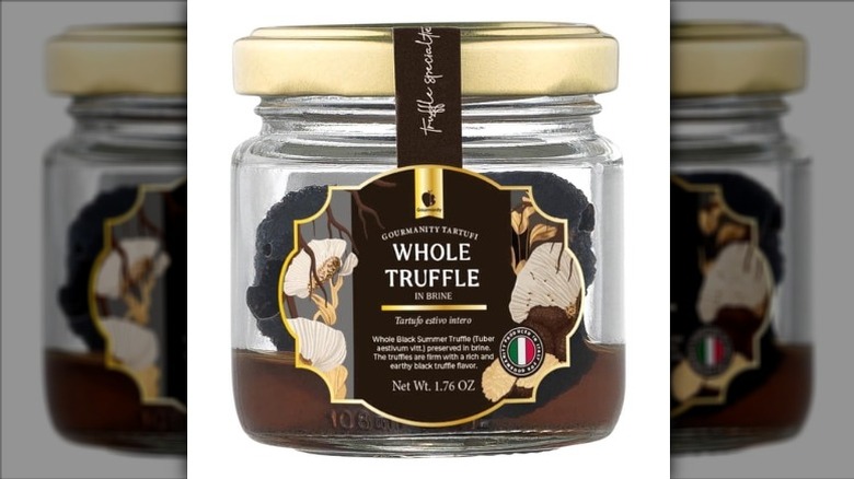 A jar of Gourmanity Tartufi Whole Black Truffles in Brine on a white background.