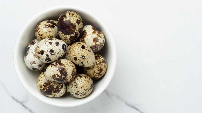 Top view of a bowl of whole quail eggs