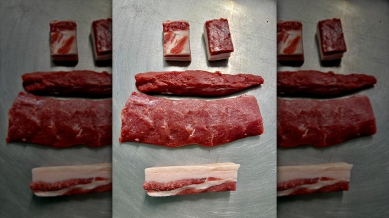 Raw wild boar tenderloins on metal surface