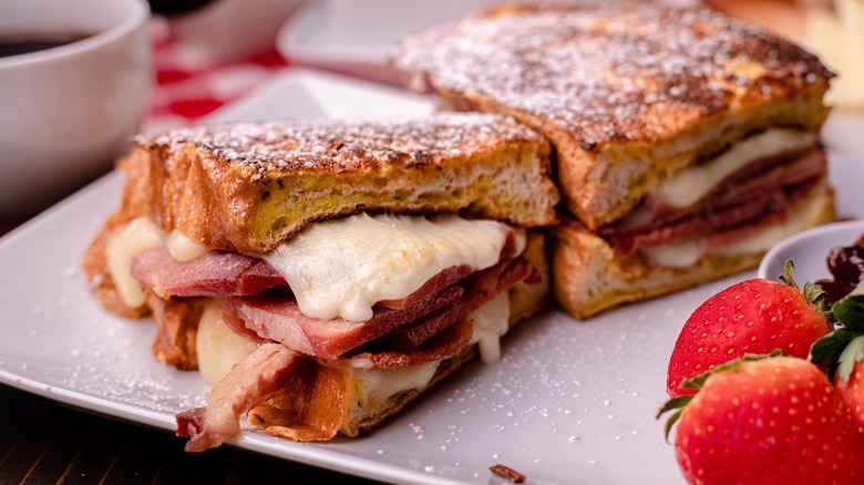 Hobe's Country Ham sandwich with melted cheese on a plate with some fresh strawberries