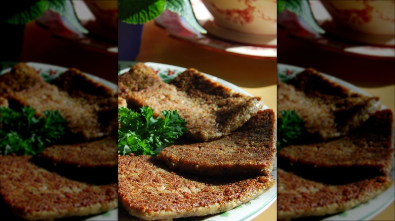 Hunter's Livermush prepared in slices on a plate with parsley sprig