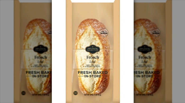 Private Selection French Loaf packaged in brown paper and clear plastic on a white background.