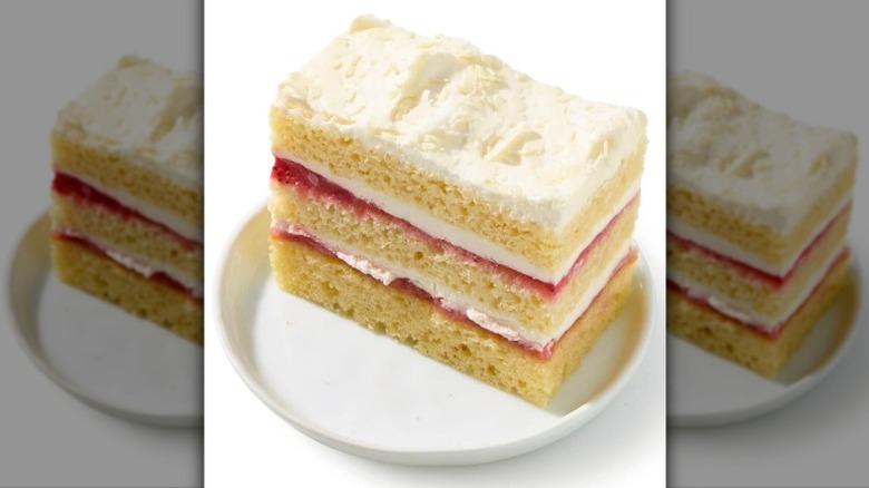 Private Selection Strawberry Shortcake Slice on a white plate on a white background.