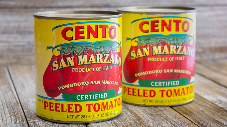 Two cans Cento San Marzano Whole Peeled Tomatoes on white background