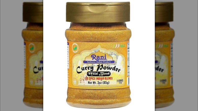 A jar of Rani Curry Powder Mild Blend on white background