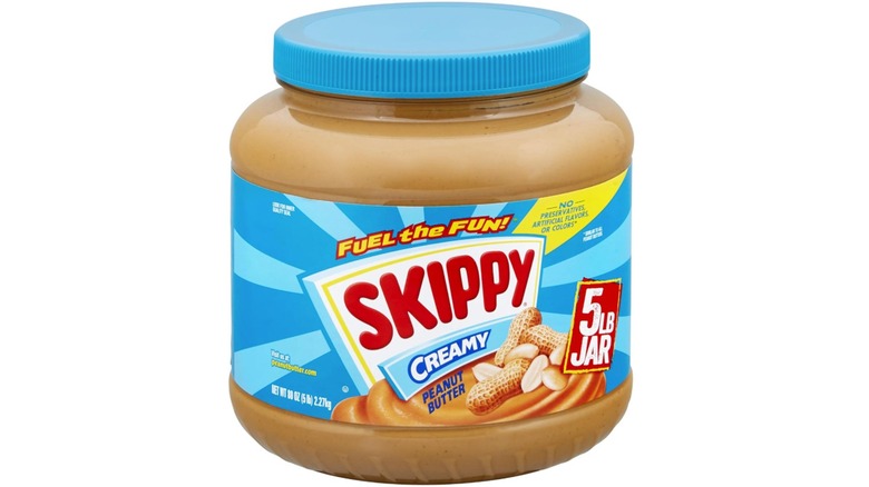 5-pound jar of Skippy Creamy Peanut Butter on white background