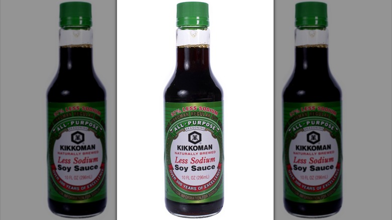 A bottle of Kikkoman Less Sodium Soy Sauce on white background