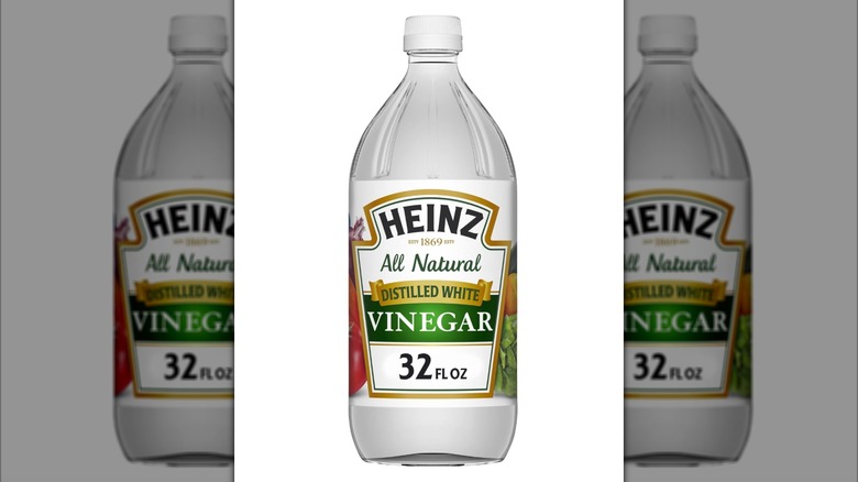 A bottle of Heinz Distilled White Vinegar on a white background