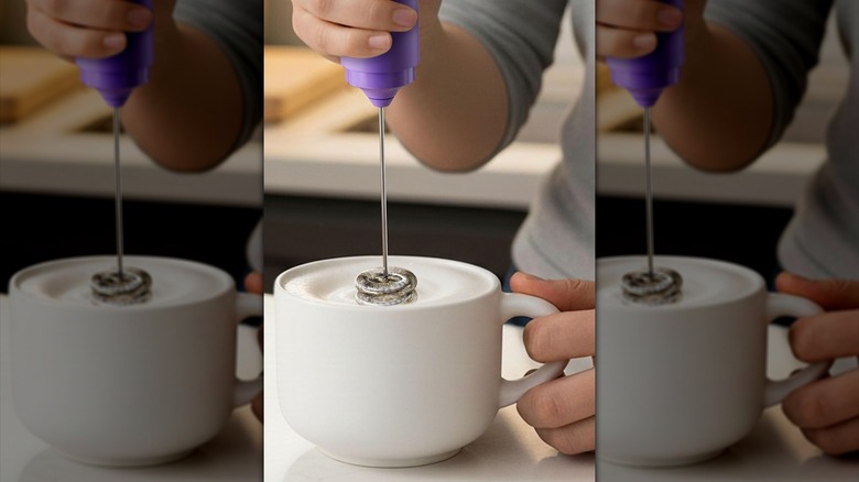 Hand frothing milk with purple New England Stories rechargeable milk frother