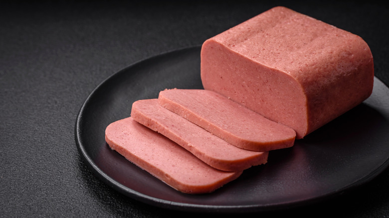 Canned ham on a plate and sliced