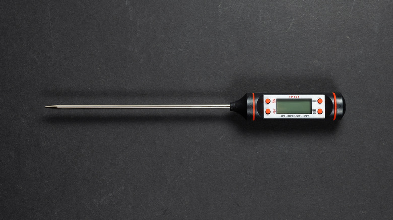 Meat thermometer on black background