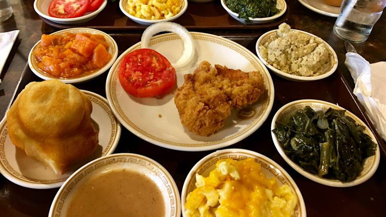 Multiple plates with comfort food on cafeteria tray
