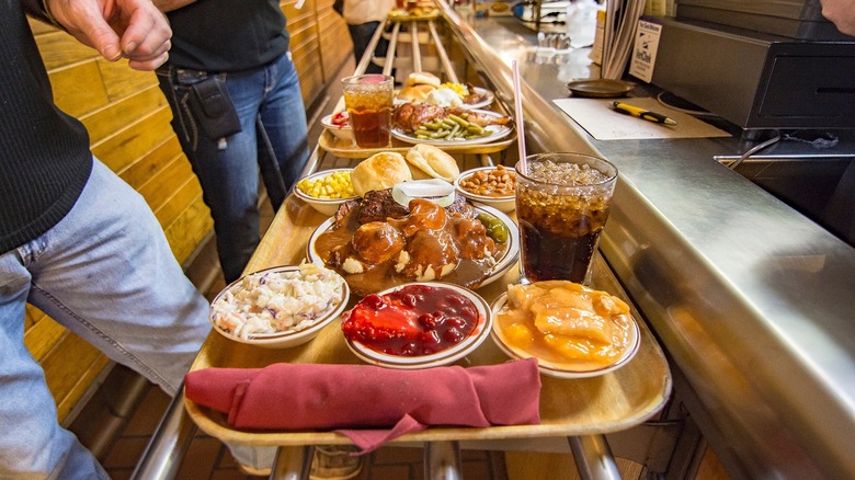 Men fill up trays in Underwood's Cafeteria line