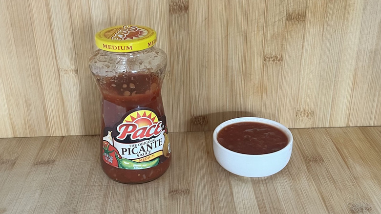 A jar and a small bowl of Pace Picante salsa