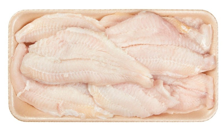 Kirkland Signature Fresh Farmed Catfish Fillets in a beige Styrofoam tray on a white background.