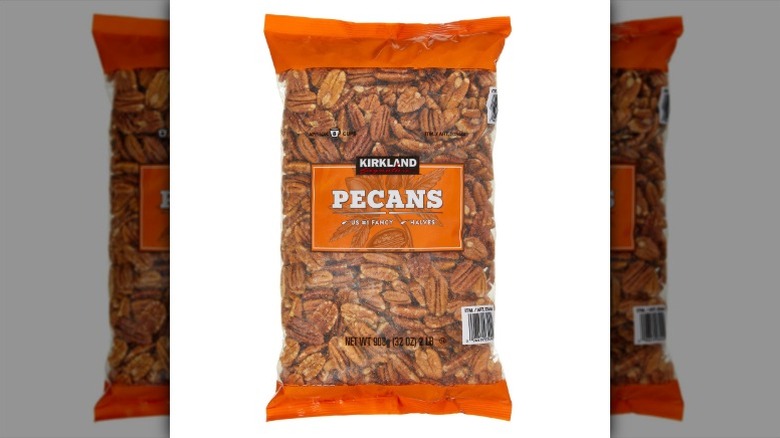 A bag of Kirkland Signature Pecan Halves on a white background.