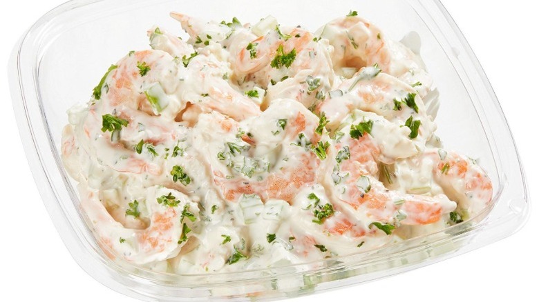 Kirkland Signature Shrimp Salad in clear plastic clamshell packaging on a white background.
