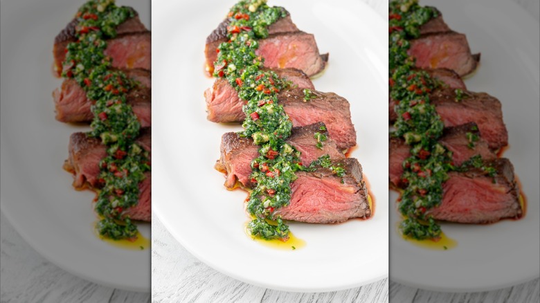 Sliced steak with chimichurri sauce, mirrored