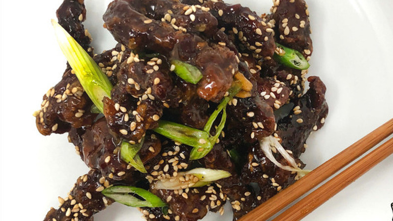 Honey garlic crispy beef with chopsticks