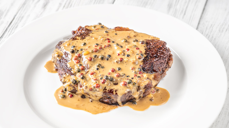 Steak au poivre on a white plate