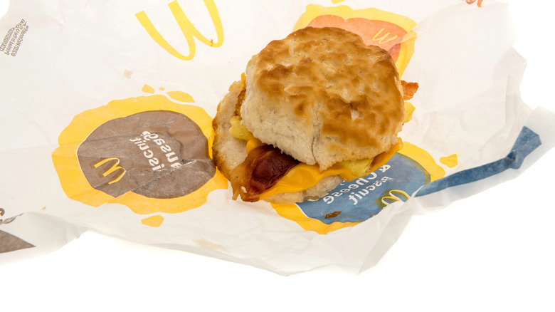 A McDonald's bacon, egg, and cheese biscuit on wax paper.
