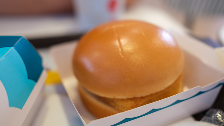 A McDonald's Filet-o-Fish sandwich resting in a cardboard box.