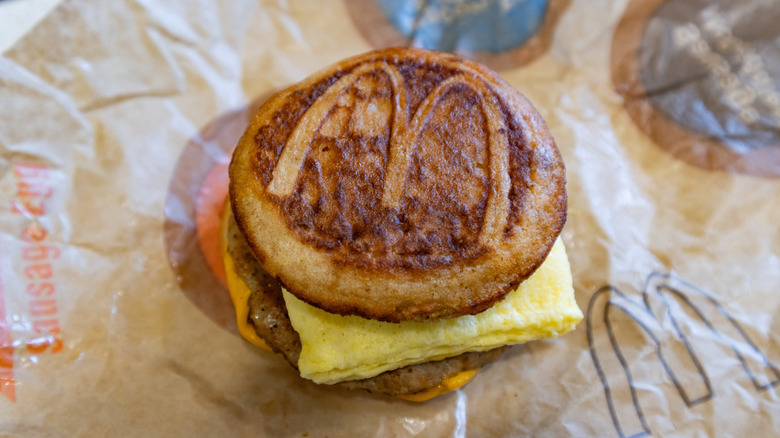 A sausage, egg, and cheese McGriddle on wax paper.