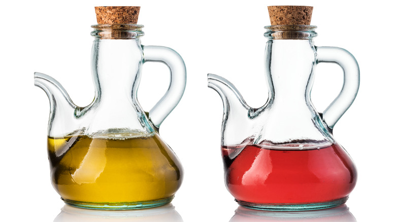 Glass jars of olive oil and red wine vinegar