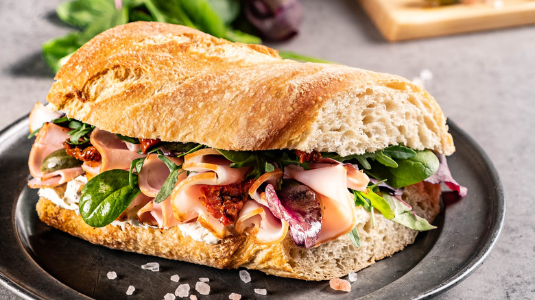 Homemade sub with meat and leafy greens