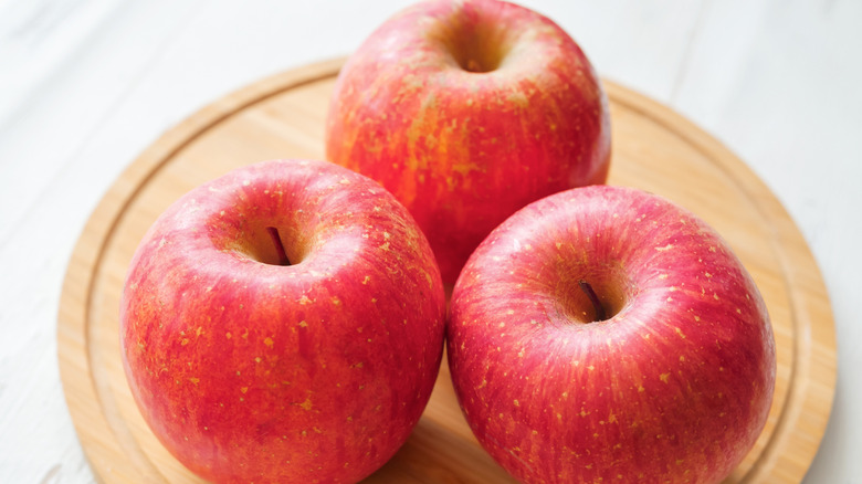 Fuji apples on a wood board