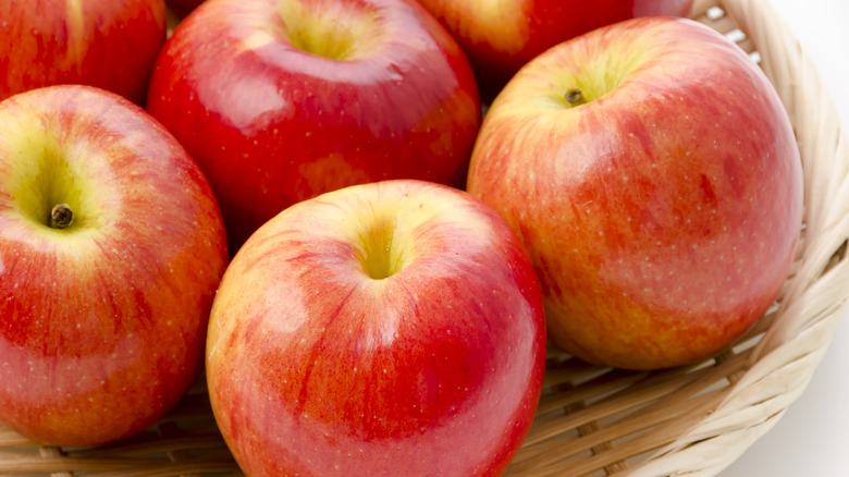 Bright red Jazz apples in bamboo basket