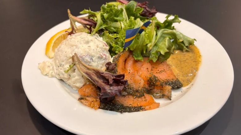 Ikea restaurant gravlax, lettuce, and potato salad on a white plate