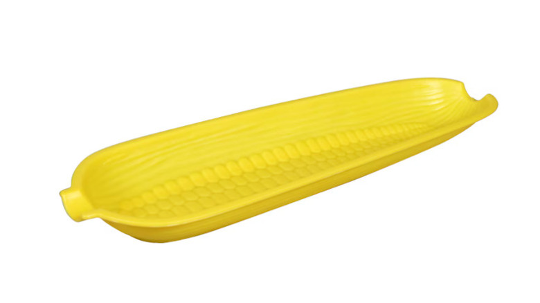 A small yellow tray shaped like an ear of shucked corn on a white background.