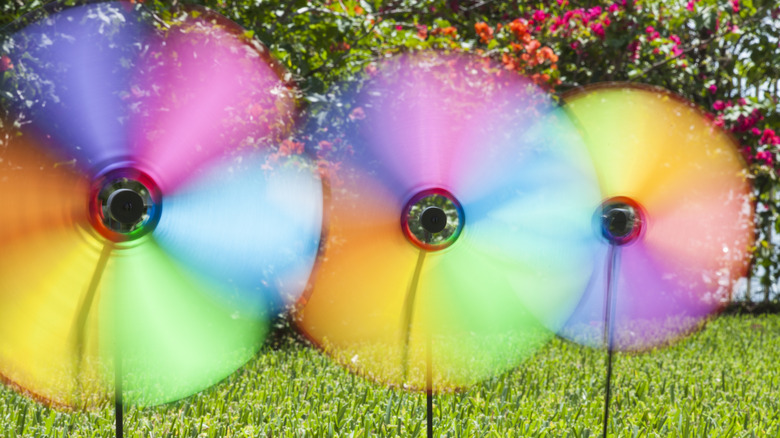 Colorful pinwheels spinning on a lawn