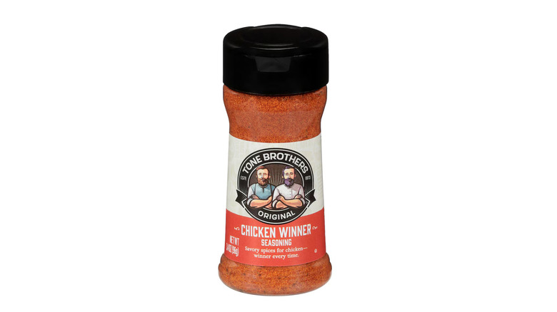 A package of reddish orange Tone Brothers Chicken Winner seasoning on a white background.