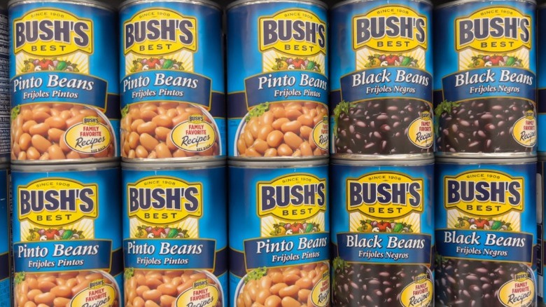 Rows of Bush's Best cans of pinto and black beans