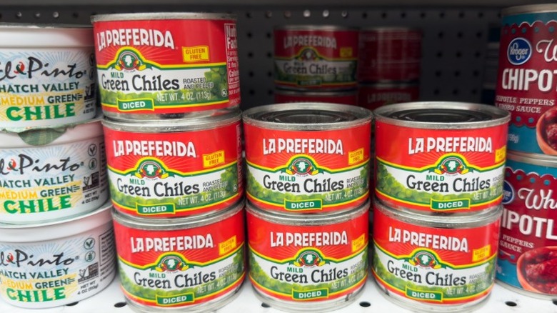 Cans of La Preferida brand green chiles on a store shelf