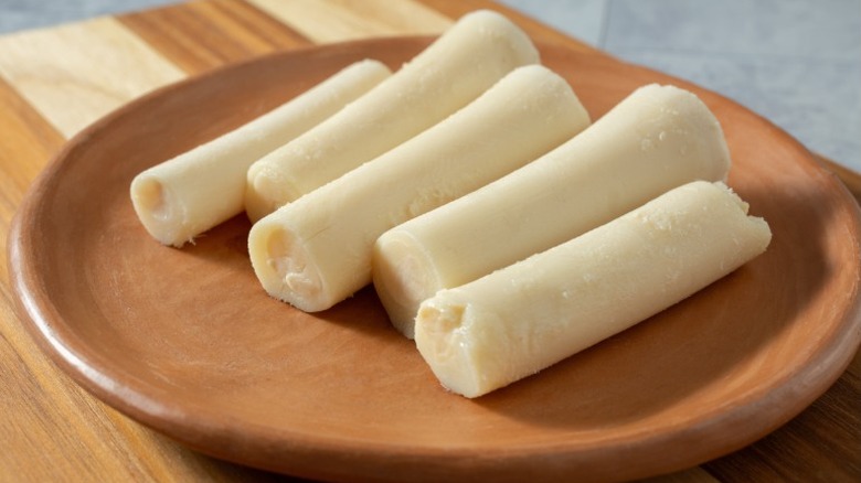 Whole hearts of palm on a brown plate