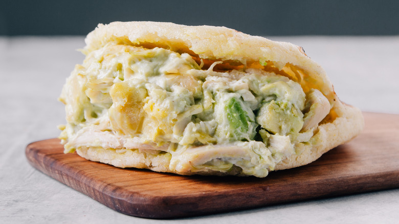 traditional arepa reina pepaida on wooden board
