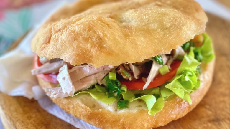 closeup of bokit with meat, lettuce, tomato
