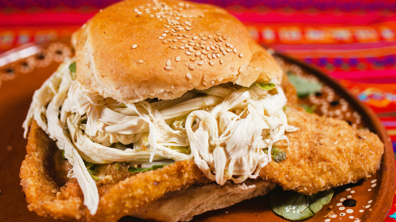 plated cemita poblana on a bright, textured backround